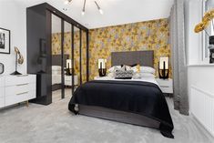 a bedroom with yellow and gray wallpaper, white bedding, and black accents