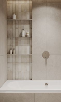 a white bath tub sitting next to a tiled wall