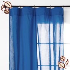 a blue curtain hanging on the side of a window