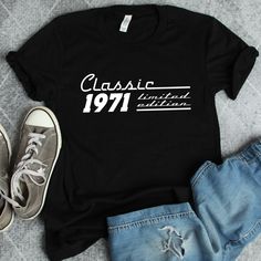 a t - shirt with the words classic 1960 on it next to jeans and sneakers