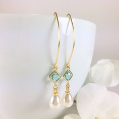 "Pearl Earrings, Gold Pearl Earrings, Pearl Dangle Earrings, Pearl Drop Earrings, Aquamarine Earrings, Aqua Pearl Earrings, Wedding Bridal Earrings, Bridesmaid Gift, Pearl Jewelry Stunning combination, these earrings are composed of a gold plated faceted aqua glass connector with a 14x8mm faux teardrop pearl dangling beneath and simply hung from long gold tone copper ear wires. Can be made in a short version if desired. Dangle length is 2-1/4\" (58mm) from the top of ear wire. Discount for multi Earrings Gold Pearl, Pearl Earrings Gold, Aqua Glass, Aquamarine Earrings, Earrings Bridesmaid, Gold Pearl Earrings, Long Dangle Earrings, Earrings Pearl, Earrings Wedding