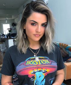 a woman with grey hair wearing a boston t - shirt