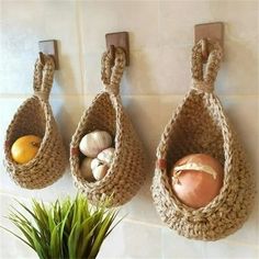 there are three baskets hanging on the wall