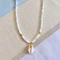 "Beautiful Cowrie Necklace  ✨Freshwater Pearls ✨ Gold-filled beads ✨24k Gold Plated Chain ✨Necklace Length : 14.5 \" + 1.5\" extension 💫 Allow 1- 3 business days for the production before shipping. 💫 All jewelry comes in a cute pouch for storage. 💫 This product is handcrafted and shipped from Palm Beach, FL." Cowrie Necklace, Seashell Choker, Cute Pouch, Cowrie Shell Necklace, Heishi Necklace, Beach Necklace, Beach Necklaces, Palm Beach Gardens, Necklace Chain Lengths