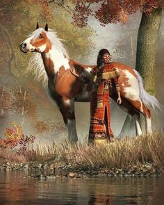 a woman standing next to a brown and white horse