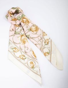 Scarves are the ultimate, versatile accessory. Style this pink, floral printed scarf in your hair, bandana-style or fashioned around your neck for an on-trend finish to your outfit. Material: Fabric Dimensions: Length 700mm x Width 700mm Weight: 41g | Lovisa Fabric Floral Chain Printed Scarf, Orange Neutral Scarf, Pale White Skin, Hair Bandana, Bandana Hair, Bandana Style, Bandana Styles, Printed Scarf, Bandana Hairstyles, Fabric Floral