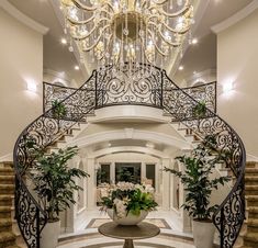 the stairs in this house are decorated with chandeliers and flowers on them,