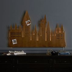 a wooden cutout of a castle on the wall above a piano in a living room