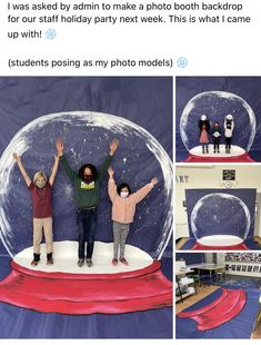 two people standing in front of a snow globe with their arms up and hands raised