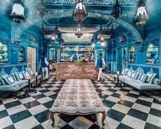 an ornately decorated room with blue walls and black and white checkered flooring