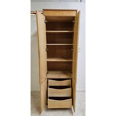 an empty wooden cabinet with drawers in it