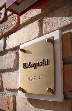 a sign that is on the side of a brick wall saying kobayashi