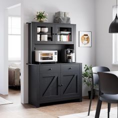 a kitchen with a microwave, cabinets and table in it's centerpieces