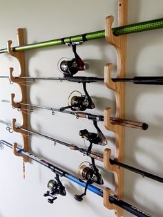 there are many fishing rods and reels hanging on the wall