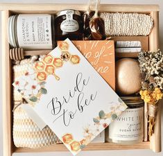 a wooden box filled with different types of wedding gifts and personal care items on top of each other