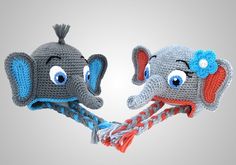 two crocheted elephant hats with blue eyes and ears, one has a flower on its head