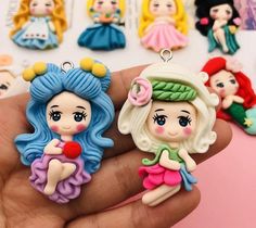 there are many little princesses on the hand and one is holding a red ball