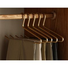 wooden clothes hangers are hanging on the wall