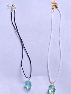 These necklace are made out of aqua sea glass charms. They are on either white wax cord with gold accents or black wax cord with silver accents. The necklace is 16 inches with an adjustable 2 inch extender. If you would like to request a certain size, please message me! White Necklace With Adjustable Waxed Cord, White Waxed Cord Necklace - Perfect Gift, White Waxed Cord Necklace For Gift, Blue Necklace With Adjustable Waxed Cord, White Minimalist Adjustable Crystal Necklace, Wax Cord Necklace, White Wax, Glass Charms, Real Pearls