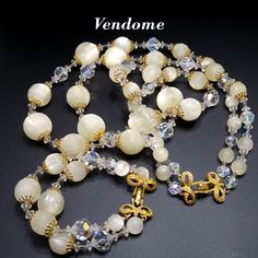 *Description: This is a gorgeous Vendome two strand necklace and matching bracelet from the 1960s. The gorgeous jewelry set has clear faceted crystal beads in several sizes and white textured orb beads in several sizes with gold plated clasps and end caps. This is a beautiful Vendome set and would be a great addition to your vintage jewelry collection or make a great vintage gift! *Approximate Measurements: Necklace Length - 23 1/2 Inches, Largest Lucite Frosty Bead - 19mm, Bracelet Length - 7 1 Vendome Jewelry, Crystal Jewelry Necklaces, Plastic Jewelry, Matching Bracelet, Amethyst Quartz, Gold Rhinestone, Gorgeous Jewelry, Faceted Crystal, Matching Bracelets