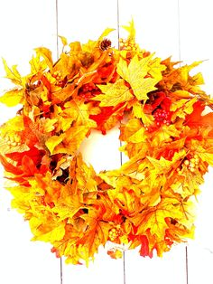 a wreath with yellow and red leaves on it