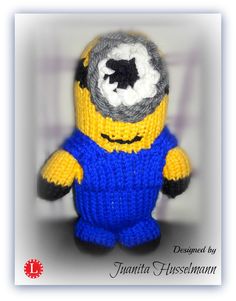 a crocheted minion is wearing a blue sweater