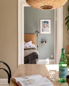 an open door leading to a bedroom with a bed and table in the foreground