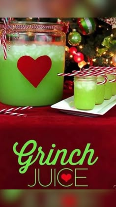 a green drink sitting on top of a table next to a christmas tree