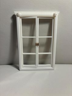 a white bookcase with glass doors on it