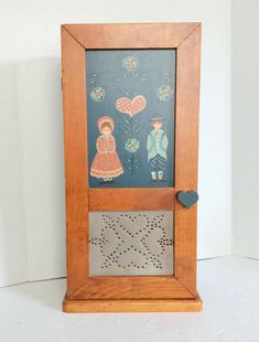 a wooden frame with an image of two people on it and a heart in the middle