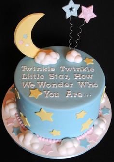 a blue cake with stars and a crescent on top that says twinkle twinkle little star, how we wonder who you are