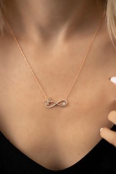 Butterfly landed on infinity symbol of the eternal love. Zircon stone enriched design is unique for representing love and freedom with butterfly at the same time. Shining zircon stones on the butterfly and the across give the necklace an attractive and eye-catching aspect. Rose Gold Infinity Necklace For Anniversary, Jewelry Necklace Simple, Rose Gold Chain Necklace, Pretty Jewelry Necklaces, Modern Gold Jewelry, Gold Chain Design, Gold Chain With Pendant, Gold Rings Fashion, Gold Fashion Necklace