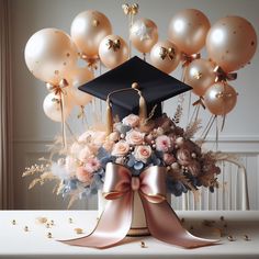 a bouquet of flowers and balloons in the shape of a graduation cap on a table