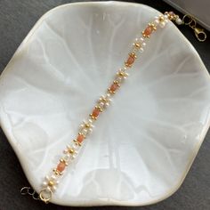 This handmade beaded bracelet features tan/ off white flowers with orange and gold accents.  Sizing: Different sizes are available. Size small fits wrists 6.5-8.5 inches, and size medium fits wrists 7.5-9.5 inches, add .5 of an inch if you prefer a looser fit. If you need a different size feel free to message me, I can make any size!  Materials: I use glass seed beads and 18k gold plated clasps/ chains. It is not recommended to wear these bracelets when you sleep, exercise, or in water.  Customi Off White Flowers, Beaded Flower Bracelet, Sleep Exercise, Daisy Bracelet, Seed Bead Bracelet, When You Sleep, Handmade Gifts For Her, Bracelets Handmade Beaded, Seed Bead Bracelets