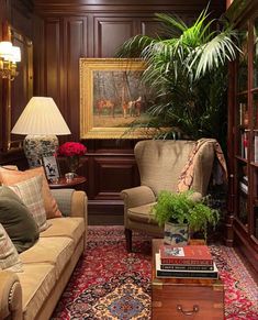 a woman sitting on a couch in a living room next to a book shelf filled with books