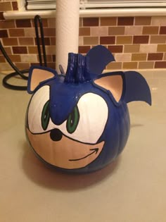 a blue and white pumpkin shaped like sonic the hedgehog on a kitchen counter top