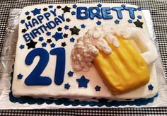 a 21st birthday cake with popcorn, beer and stars on the tableclothed table cloth