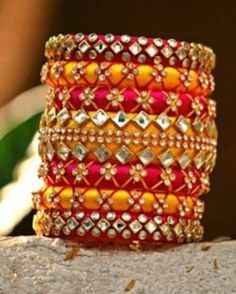 Bangles is an Indian artistic handcraft brand set out to create mesmerizing designs that people would desire to keep and treasure. Every woman is a balance of Beauty, Power & Elegance and we at Bangles aspire to compliment & showcase this Balance. Indian Beauty resides in vibrant colors and soothing elegance, two things that traditionally don't mix together. Elegance demands tranquility while Vibrancy demands energy. Bride And Groom Name Bangles Handmade Pink Bracelets For Diwali, Pink Handmade Bracelet For Diwali, Handmade Pink Bracelet For Diwali, Pink Handmade Traditional Bangle, Festive Handwork Bangle, Handwork Bangle Bracelets For Festivals, Handwork Bangle Bracelets For Diwali, Handwork Bracelets For Festivals Gift, Diwali Bangle Bracelets With Handwork