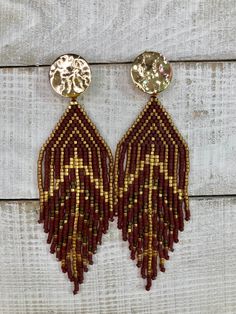 Beautiful beaded fringe earrings that have been hand sewn and beaded by myself. Beaded with miyuki Delica beads in brown and gold tones to give an autumnal feel. The gold findings are 14k gold plated. Nylon thread is used to give movement to the fringe. Note: when storing fringe earrings it is best to lay them flat or have them hanging by the ear wires. 3.5 inches from drop and 1 inch in width  The earrings were designed by PenguBeading on Etsy. Gold Tassel Earrings With Colorful Beads, Brown Beaded Fringe Dangle Earrings, Brown Dangle Beaded Earrings With Fringe, Bohemian Brown Beaded Earrings With Gold Beads, Brown Fringe Dangle Beaded Earrings, Brown Beaded Earrings With Fringe, Gold Beaded Fringe Dangle Earrings, Gold Tassel Earrings With Beaded Fringe, Brown Beaded Dangle Tassel Earrings