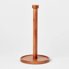 a wooden stand with a round base on the top and one leg in the middle