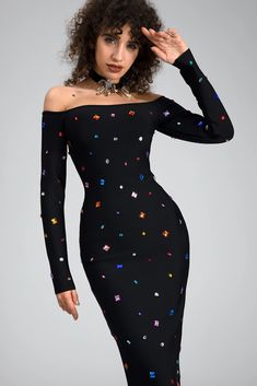 a woman wearing a black dress with colorful stars on it