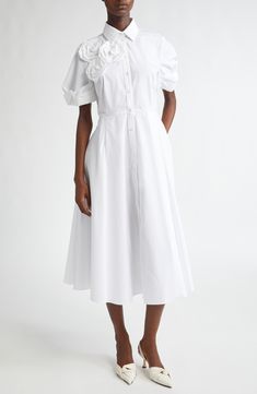 A classic shirtdress tailored with a flared skirt from lightweight cotton poplin gets a fresh look via oversized rosettes and pleat-detailed twisted cuffs. 48 1/2" length (size 16 UK) Front button closure Spread collar Short sleeves Lined 100% cotton Dry clean or machine wash, line dry Imported Designer Clothing Fresh Look, Flared Skirt, Shirtdress, Flare Skirt, Cotton Poplin, Sleeve Cotton, Clothing Items, Size 16, Designer Clothing