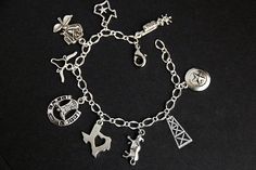 A collection of silver plated Texas themed charms have been dispersed around a shimmering silver plated bracelet chain in this handmade charm bracelet. This Texas charm bracelet is then completed with a lobster clasp and a 1/2 inch of chain at the end for adjustable sizing. Charms in this bracelet include two Texas state charms, a lone-star charm, an oil rig charm, bull charm, Texas rose charm, boot spurs charm, horseshoe with cowboy boots charm, and a long horn charm. ● Sizing ● To determine yo Personalized Symbolic Silver Bracelets, Symbolic Silver Bracelets With Charms, Symbolic Silver Bracelets With Dangling Charms, Silver Symbolic Bracelets With Dangling Charms, Symbolic Silver Bracelet With Dangling Charms, Symbolic Sterling Silver Charm Bracelet, Symbolic Silver Hypoallergenic Charm Bracelet, Silver Symbolic Charm Bracelet Hypoallergenic, Silver Adjustable Chain Bracelet With Dangling Charms