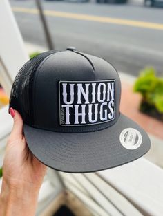 Union Thugs HAT DESCRIPTION: ORIGINAL - YP Classic snapback - 80/20 acrylic/wool - Structured, six-panel, high-profile - Flat bill with GREEN undervisor - Snapback closure NET BACK -Classic Trucker hat * Classic trucker cap with premium mesh panels * Hard buckram. Structured * Matching plastic snapback closure -------------------------- HARD MEASUREMENTS:  Crown Height   -   3 3/4" Hat size   -    6 5/8-7 3/8 -------------------------- COLORS: -Black - Regular & Net -Camo - Regular  -Camo Black net & Green net -Black Camo -Navy Blue -Charcoal/Black -Mesh -Red - Black Mesh ------------------------ ISSUES? DM me & ill do my best to fix the problem! Urban Trucker Hat With Flat Bill And Logo Patch, Urban Trucker Hat With Logo Patch And Flat Bill, Urban Trucker Hat With Logo Patch, Urban Adjustable Trucker Hat With Logo Patch, Trucker Hat With Letter Patch Snapback, Streetwear Hats With Logo Patch And Curved Brim, Curved Brim Hat With Logo Patch For Streetwear, Urban Baseball Cap With Logo Patch And Flat Brim, Trucker Hat With Letter Patch And Flat Brim