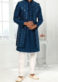 Readymade Art Silk Sherwani, and Jacket. Art Dupion Aligarhi Ready Made Trouser. Resham, Sequences, and Zari Work. Crafted in Chinese Collar Neck, and Full Sleeve. Faux Satin Lining with Plain Work. High-Quality Matching Buttons. Please Note: The footwear shown in the picture is for presentation and photography purpose only. Color: There might be slight color variation due to lightings and flashes while photo shooting. The color may also vary because of different screen resolutions. Wash Care: D Festive Long Fitted Outerwear, Traditional Fitted Long Coat, Fitted Long Outerwear For Festive Season, Traditional Long Coat For Festive Season, Fitted Long Nehru Jacket For Winter, Bollywood Style Fitted Outerwear With Resham Embroidery, Formal Festive Sets With Front Open, Traditional Long Nehru Jacket For Winter, Bollywood Style Outerwear With Zari Work For Festive Season