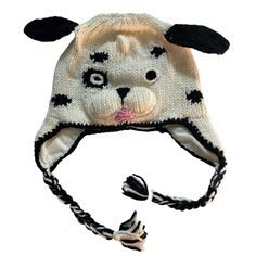 a knitted animal hat with black ears and eyes