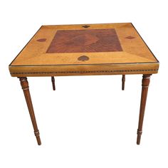 a small wooden table with an intricate design on the top