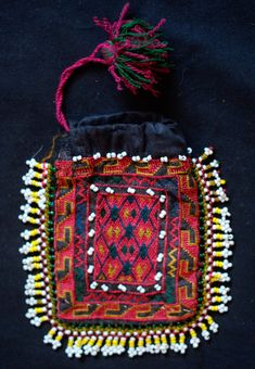 This is a beautiful silk embroidered Uzbek pouch. It has glass beads all around the edges. The inner lining is in a cotton material. The workmanship is exquisite. -Silk embroidery -Glass beads Luxury Embroidered Art Silk Fabric With Zari Weaving, Traditional Beaded Rectangular Pouch, Multicolor Embroidered Pouch For Festivals, Bohemian Embroidered Pouch For Festivals, Traditional Embroidered Pouch For Festivals, Traditional Pouch With Intricate Embroidery For Festivals, Traditional Festival Pouch With Intricate Embroidery, Traditional Handmade Multicolor Embroidered Pouch, Traditional Handmade Pouch With Multicolor Embroidery