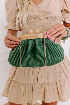 - Pull your look together with this sweet purse! Its woven design and wooden clasp make it the perfect for summer style. It easily elevates your OOTD giving it a laid-back yet chic vibe. - A fully lined pouch - Woven raffia material - Gold colored metal hardware - A magnetic wooden ball clasp closure - A removable chain strap - A zippered interior pocket Green Summer Straw Pouch Bag, Green Pouch Straw Bag For Vacation, Chic Green Straw Bag For The Beach, Chic Green Straw Bag For Beach, Green Rectangular Clutch For Beach, Green Pouch-shaped Straw Bag, Green Pouch Clutch For Summer, Chic Summer Clutch With Braided Handles, Chic Woven Clutch For Spring