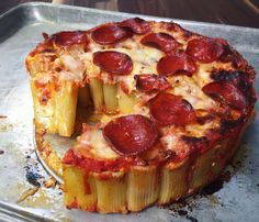 a pepperoni pizza is cut in half and placed on top of a metal pan